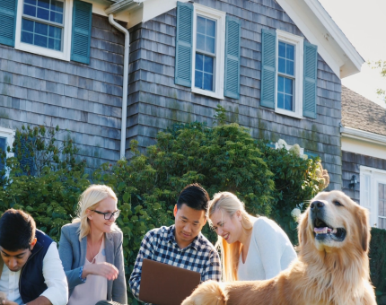 Group of people laying on the ground with golden retriever